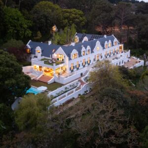 Aerial view of Stillness Manor in Cape Town’s Zwaanswyk suburb surrounded by lush greenery.